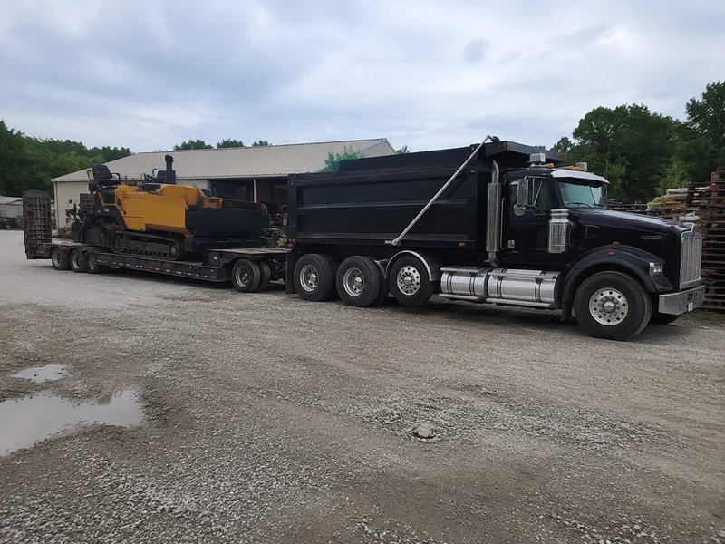 Asphalt Paving Lafayette dump truck and paver on the equipment yard