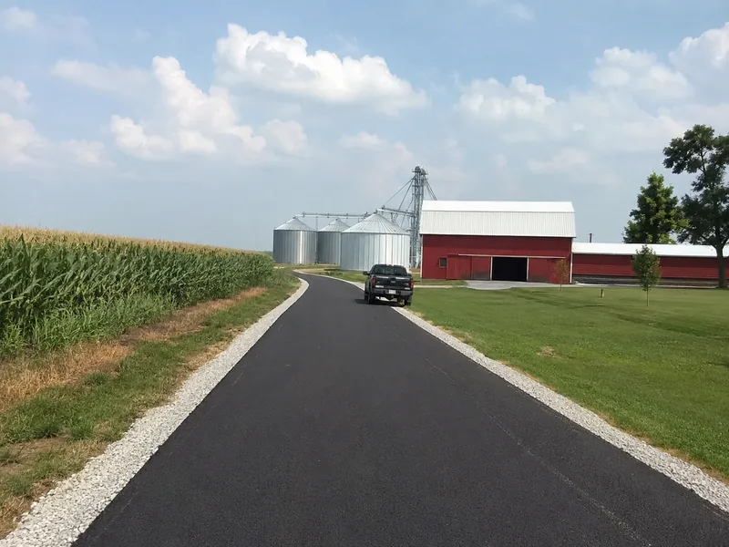 New asphalt farm lane leading to a barn and grain bins near Lafayette Indiana